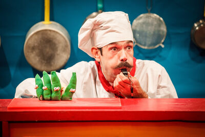 Chef with a whistle next to beans