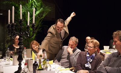 Basil pours wine for a guest